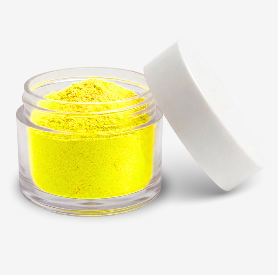 A small clear plastic jar filled with bright yellow food colouring powder, shown with its white lid leaning against it on a clean white background.