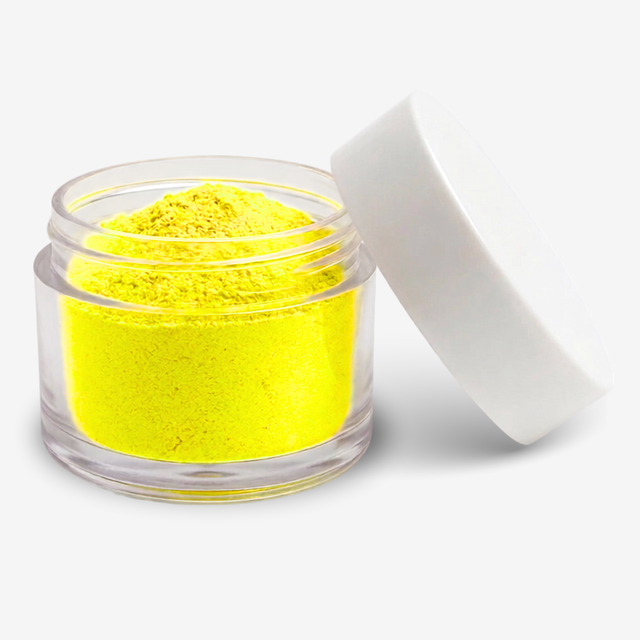 A small clear plastic jar filled with bright yellow food colouring powder, shown with its white lid leaning against it on a clean white background.