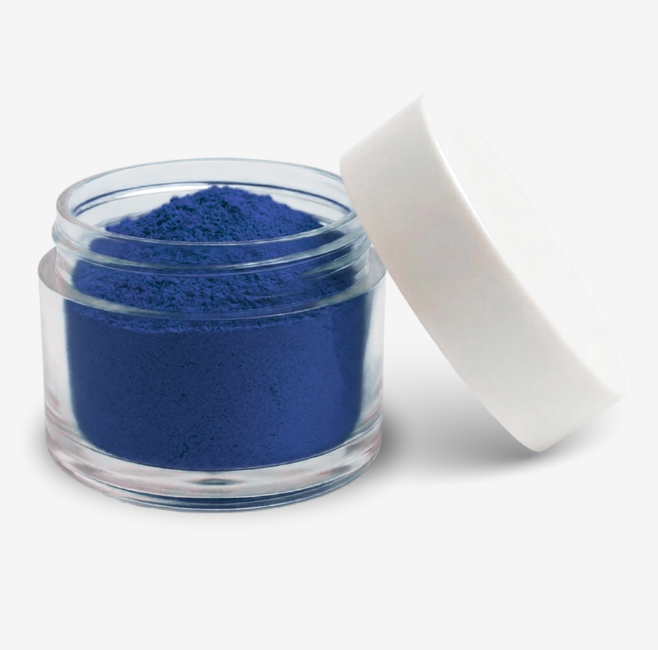 A small clear plastic jar filled with blue food colouring powder, shown with a white screw-on lid leaning against it on a clean white background.