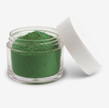 A small clear plastic jar filled with green food colouring powder, shown with a white lid leaning against it on a clean white background.