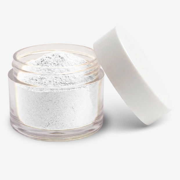 A clear round jar filled with white food colouring powder, shown open with a white lid leaning against it on a clean white background.