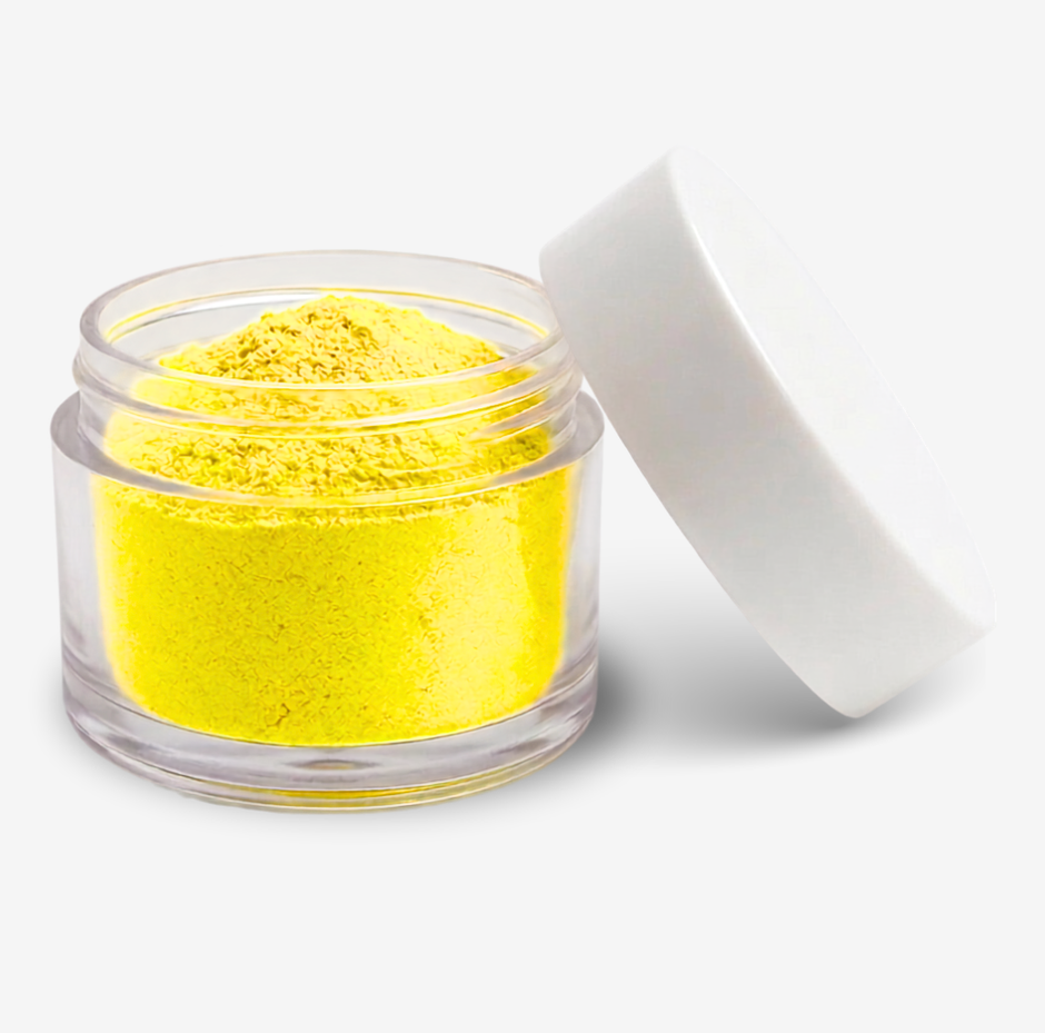 A small clear jar filled with yellow food colouring powder, shown with its white lid leaning against it on a clean white background.